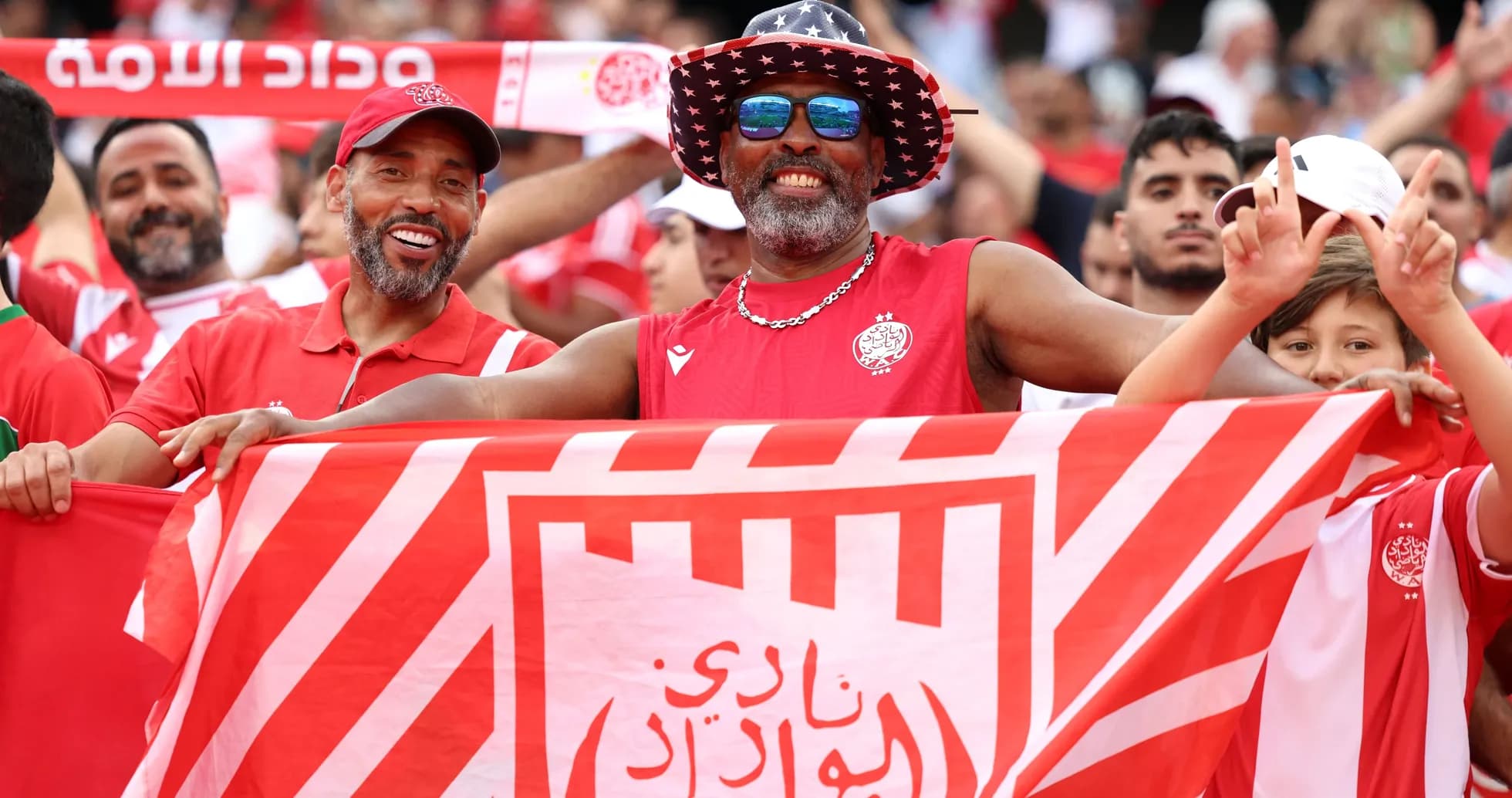 Supporters celebrating with a flag at a match