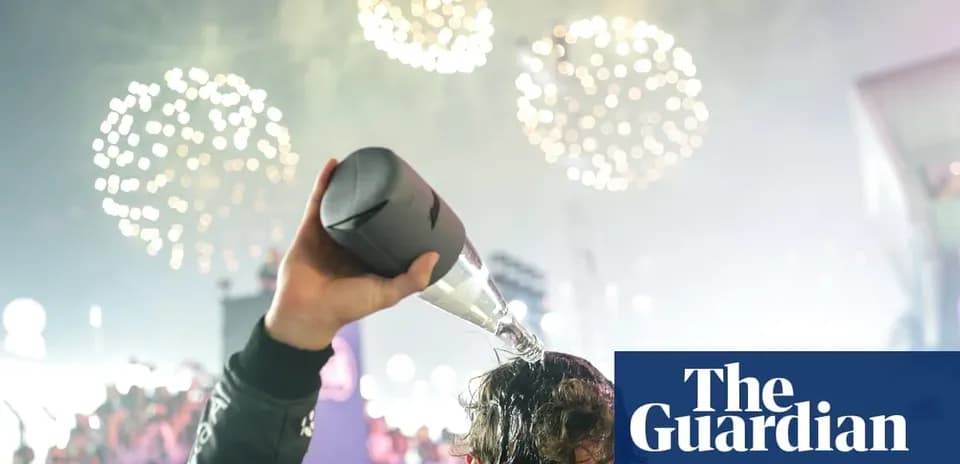 Person pouring champagne on their head with fireworks