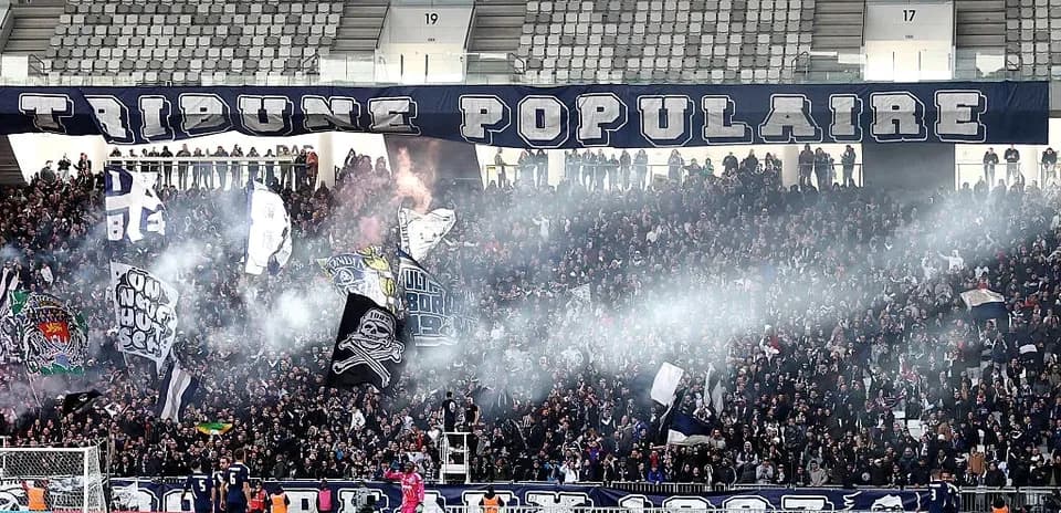 Supporters with flags in stadium during match