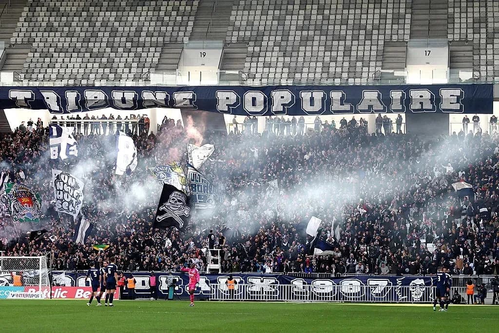Supporters with flags in stadium during match