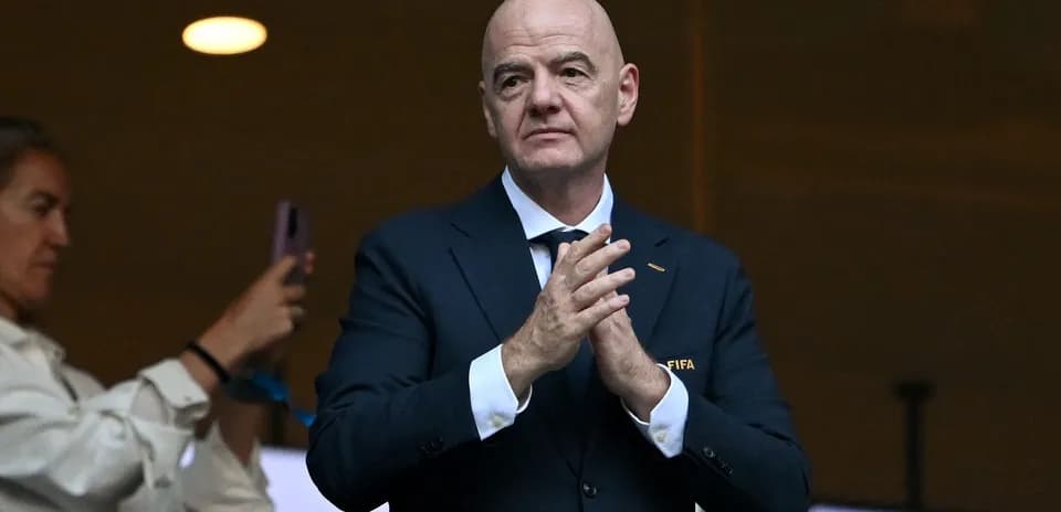 Homme en costume applaudissant dans un stade