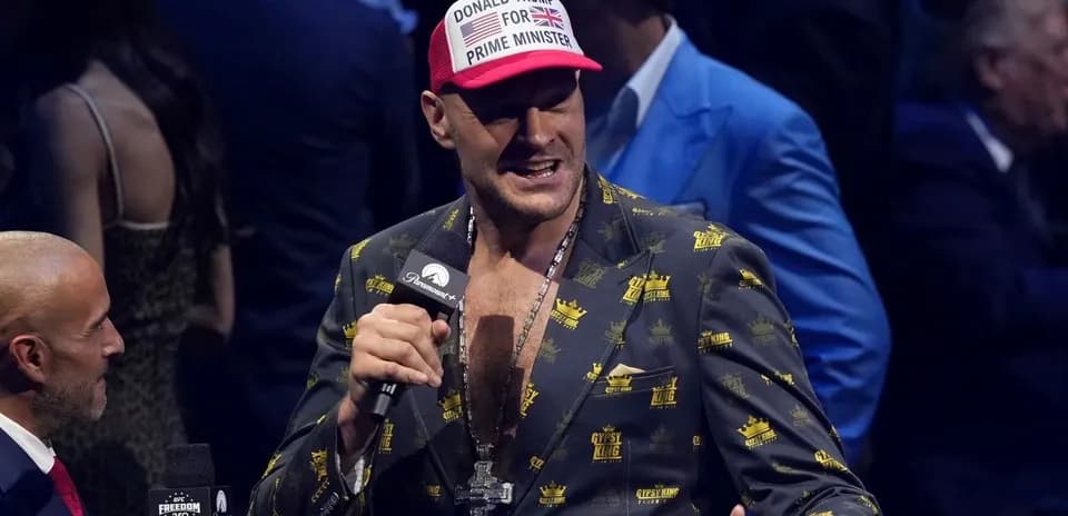Tyson Fury speaking at an event with microphone