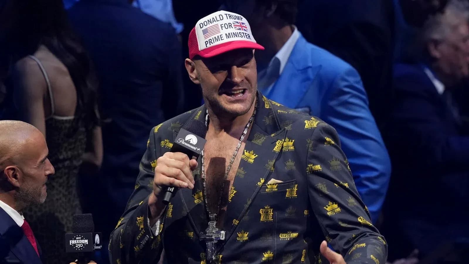 Tyson Fury speaking at an event with microphone