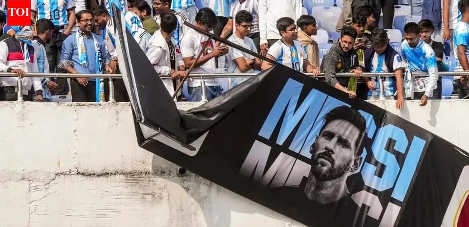Supporters with Argentina jerseys near Messi banner