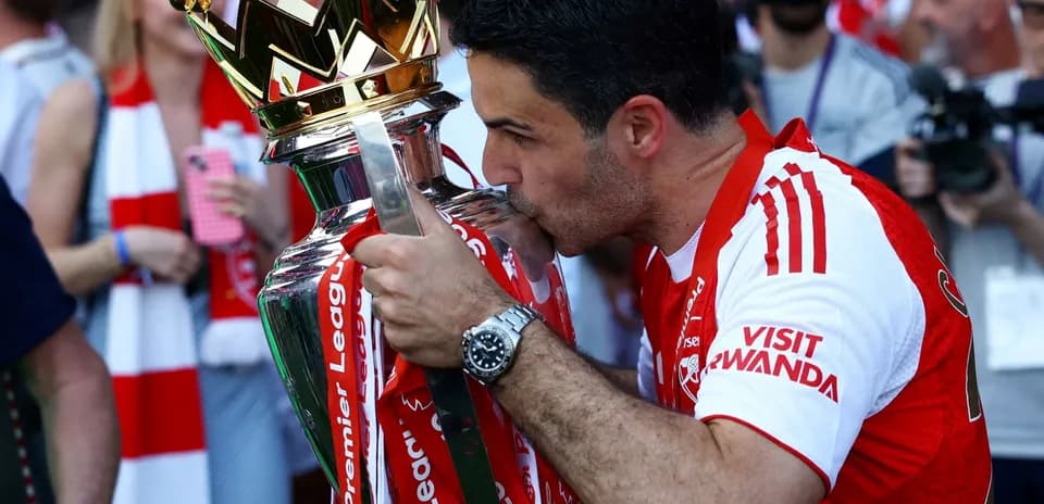 Entraîneur embrassant le trophée de la Premier League