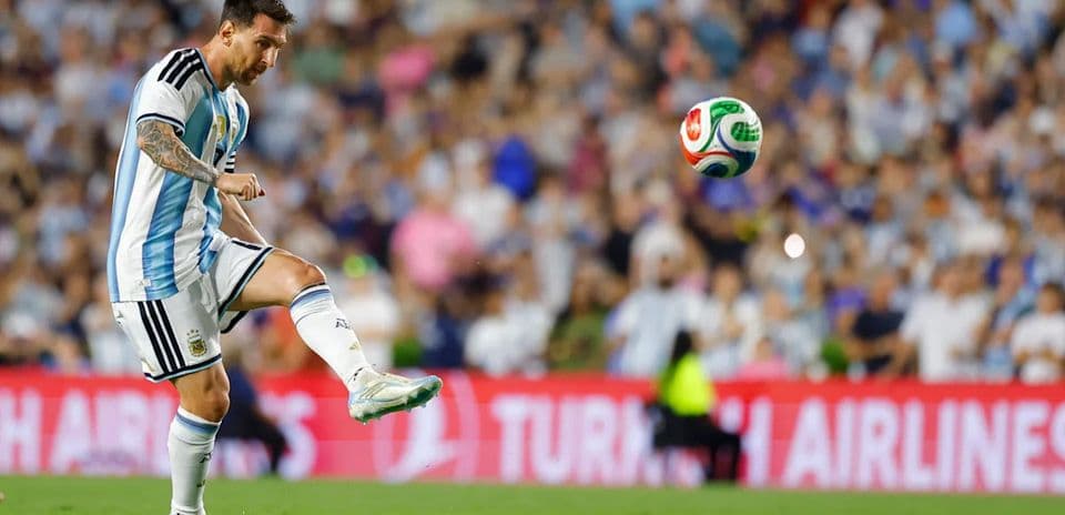 Lionel Messi preparing to kick the soccer ball