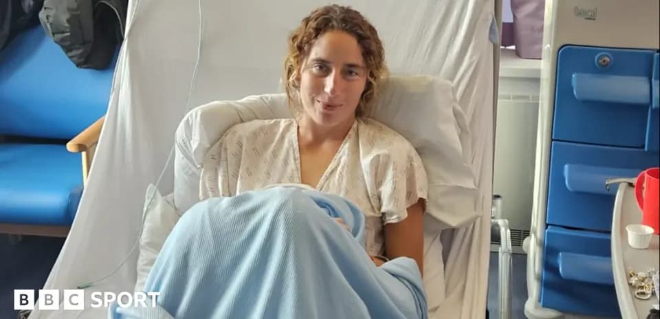 Athlete recovering in hospital bed with blanket