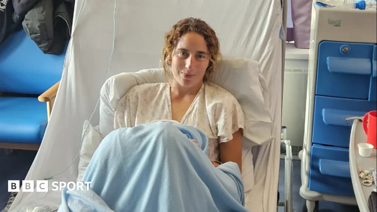 Athlete recovering in hospital bed with blanket
