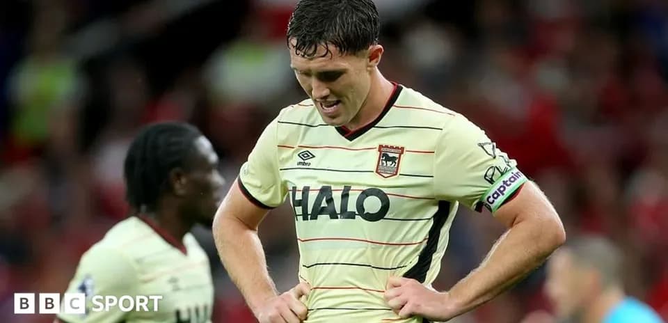 Joueur avec le maillot de son équipe, la tête baissée