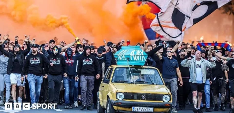 Supporters marching with flares and banners