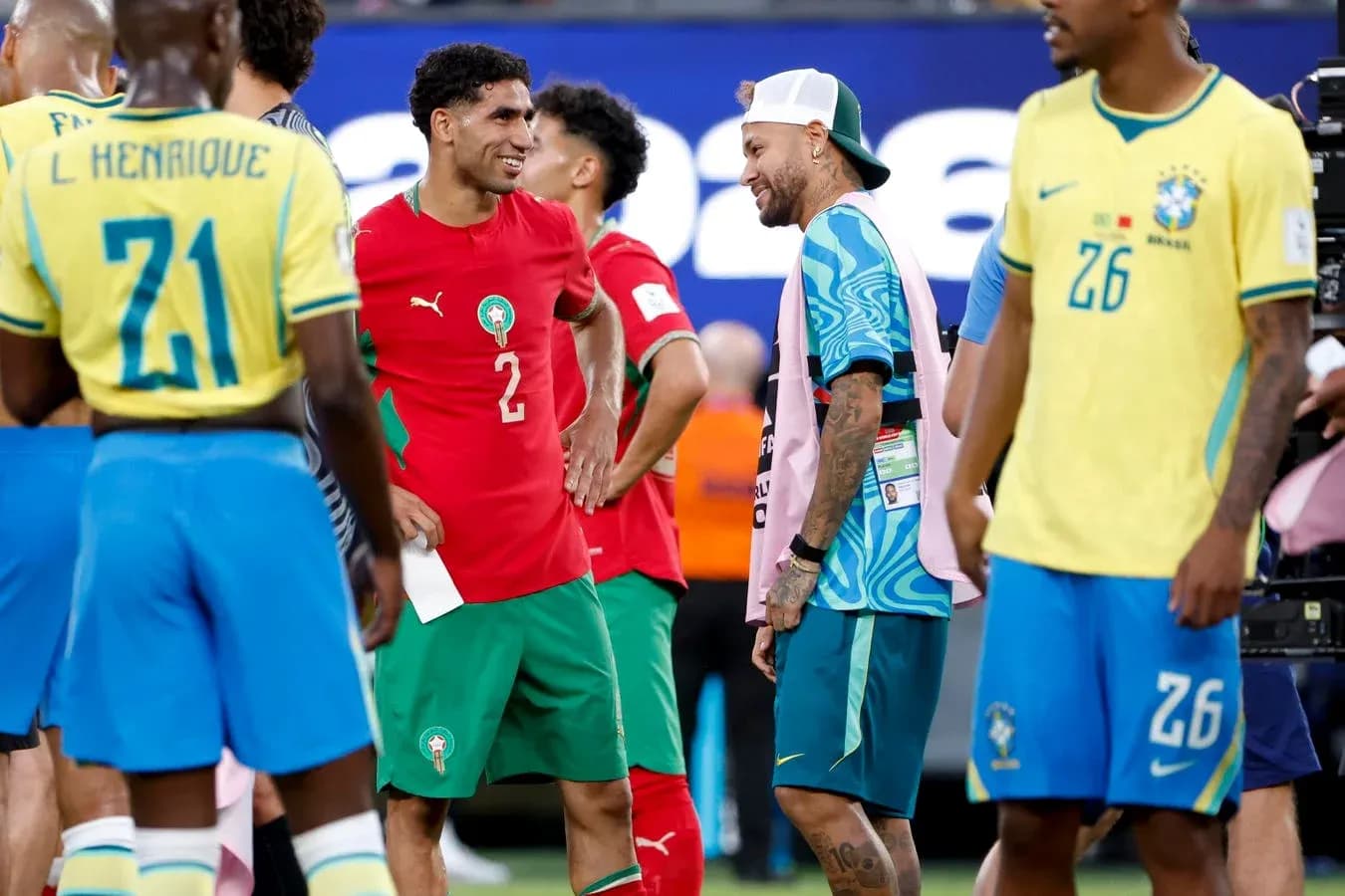 Joueurs marocains et brésiliens discutant sur le terrain