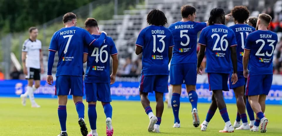 Joueurs en maillot bleu célébrant sur le terrain