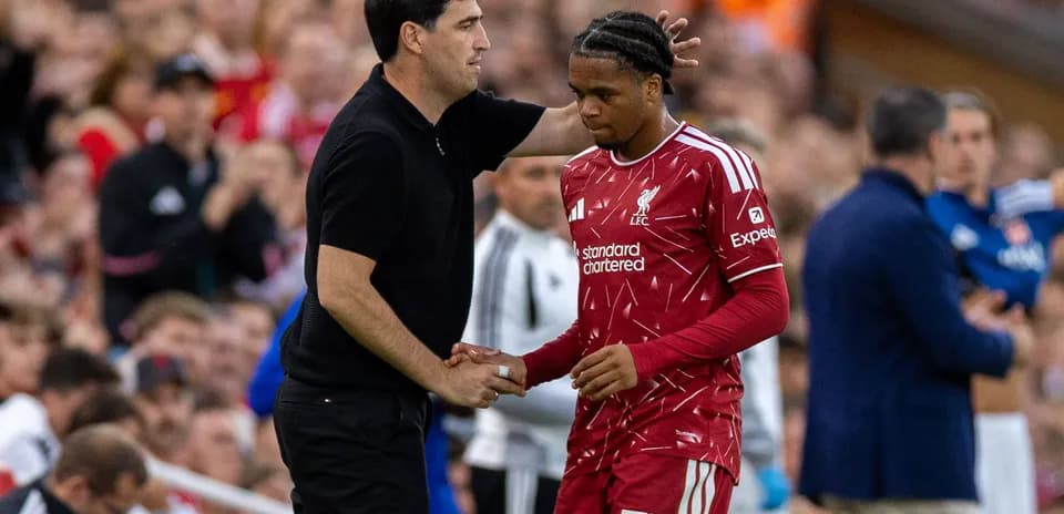 Entraîneur parlant à un joueur de Liverpool sur le banc