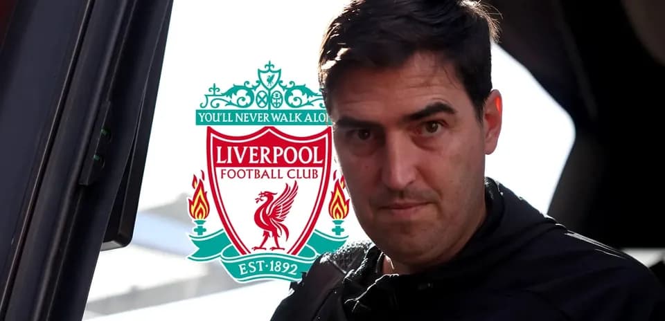 Person near Liverpool FC logo before match
