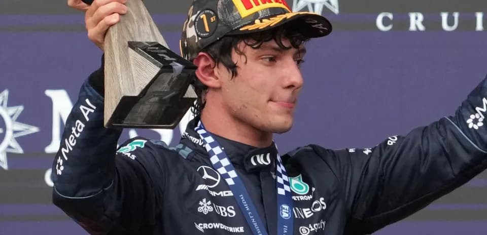 Pilote tenant un trophée sur le podium de la course