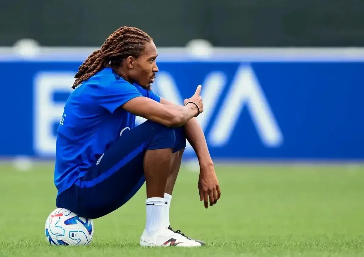 Joueur assis sur le terrain avec un ballon