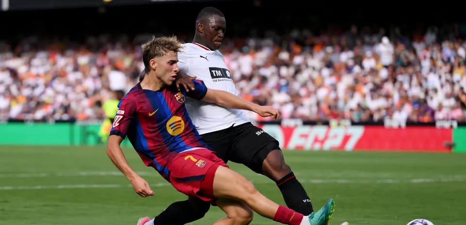 Joueur de Barcelone taclant un adversaire en match