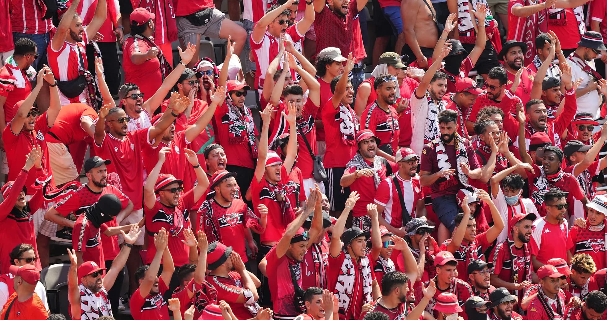 Supporters in red cheering during a match