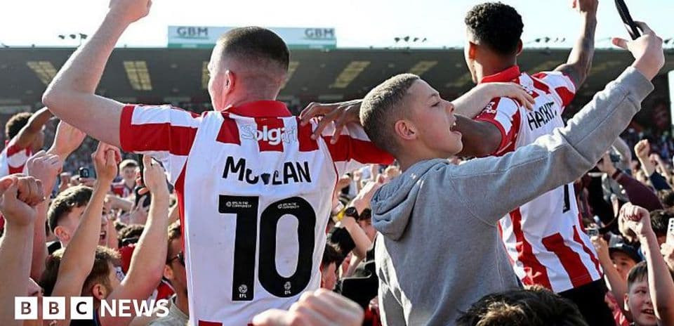 Supporters celebrating with players after the match