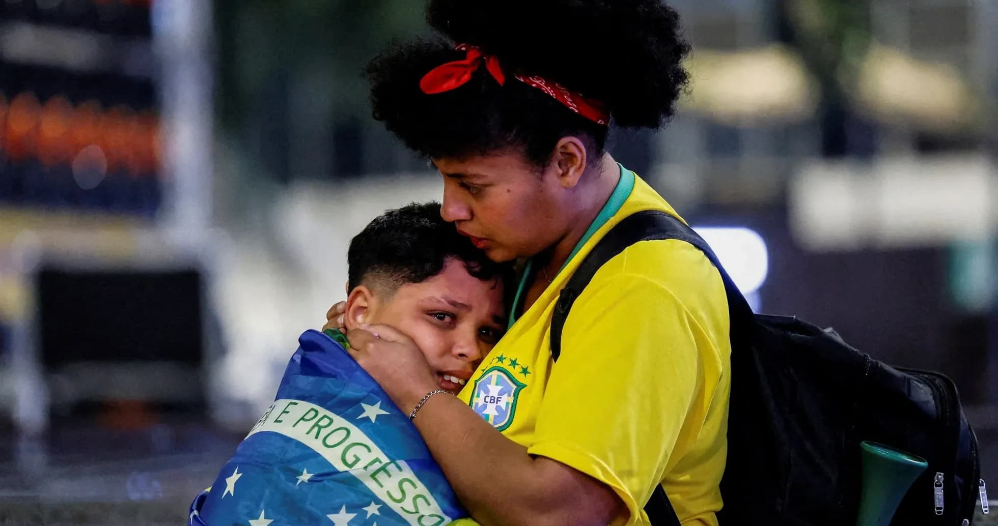 Supporters embracing, wrapped in Brazilian flag Supporters embracing, wrapped in Brazilian flag
