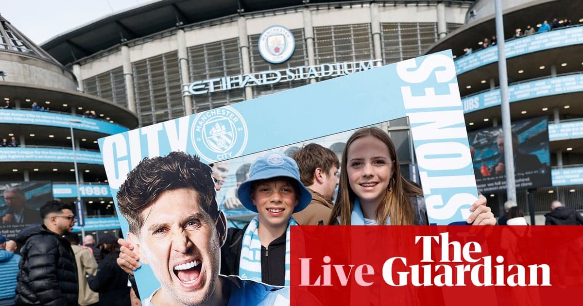Supporters holding Manchester City sign at Etihad Stadium Supporters holding Manchester City sign at Etihad Stadium