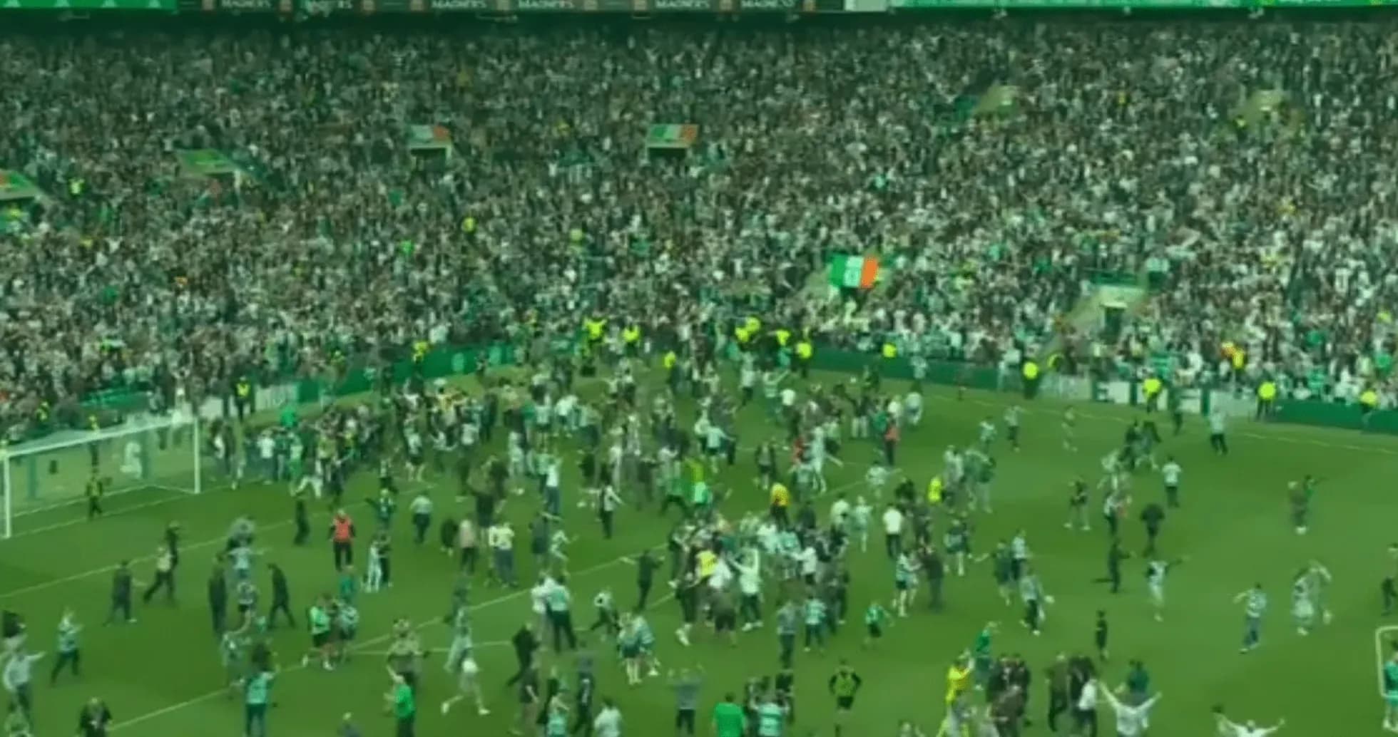 Supporters celebrating on the pitch after match Supporters celebrating on the pitch after match