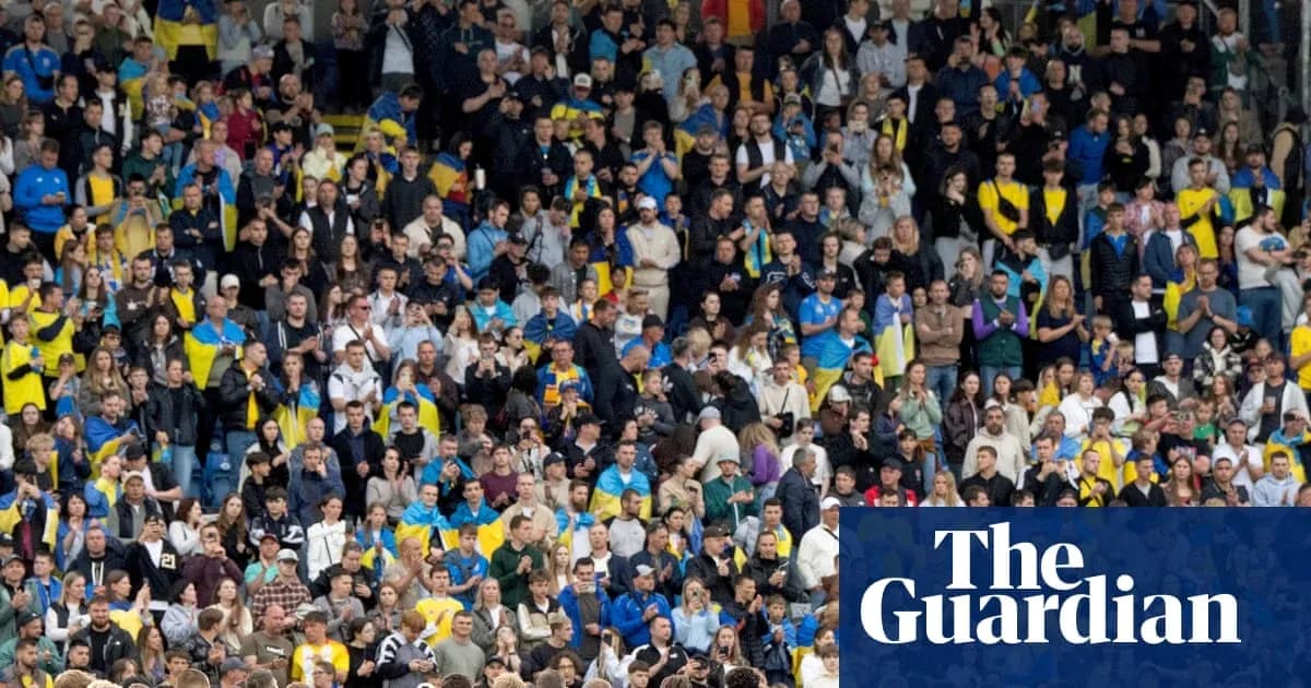 Supporters in stadium wearing team colors and cheering Supporters in stadium wearing team colors and cheering