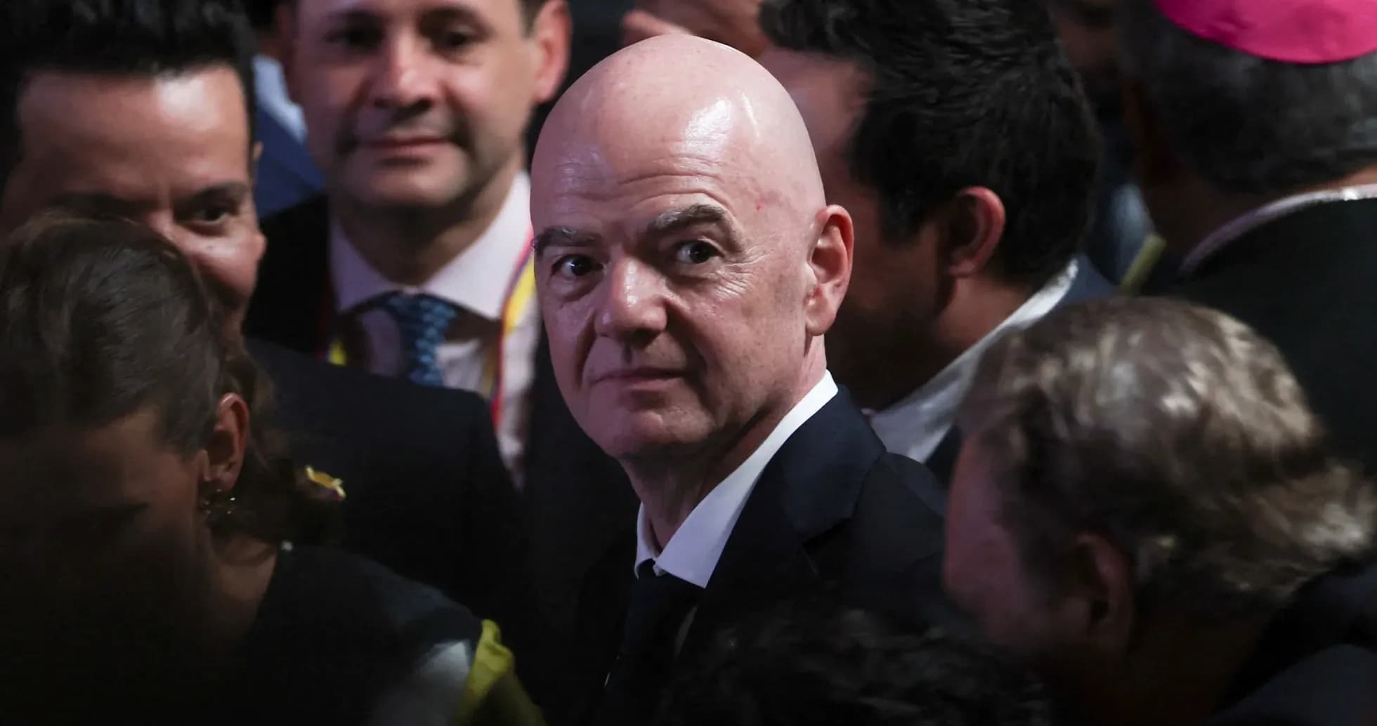 Person in suit surrounded by a crowd at event Person in suit surrounded by a crowd at event