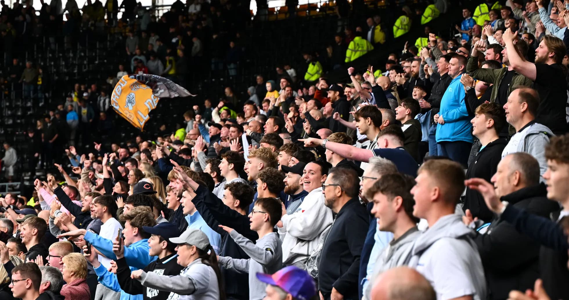 Supporters cheering in stadium during match Supporters cheering in stadium during match