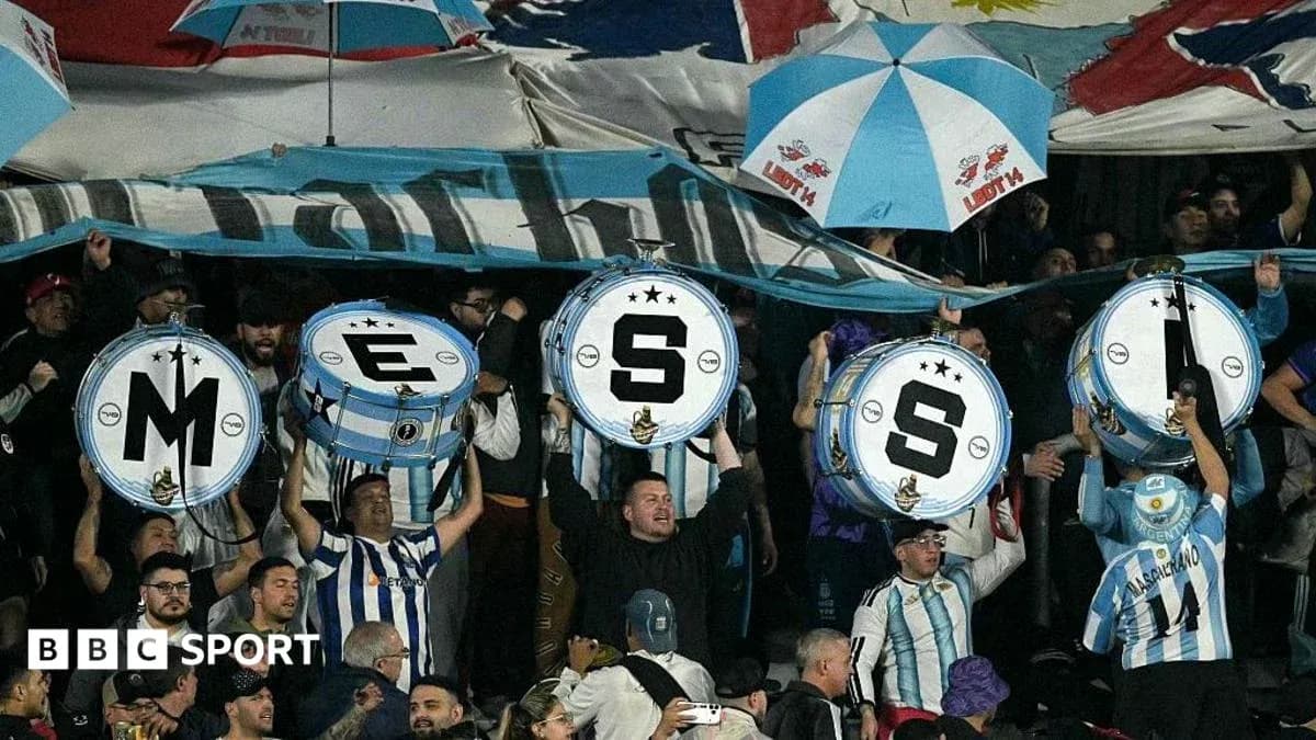 Supporters holding drums with letters at match Supporters holding drums with letters at match