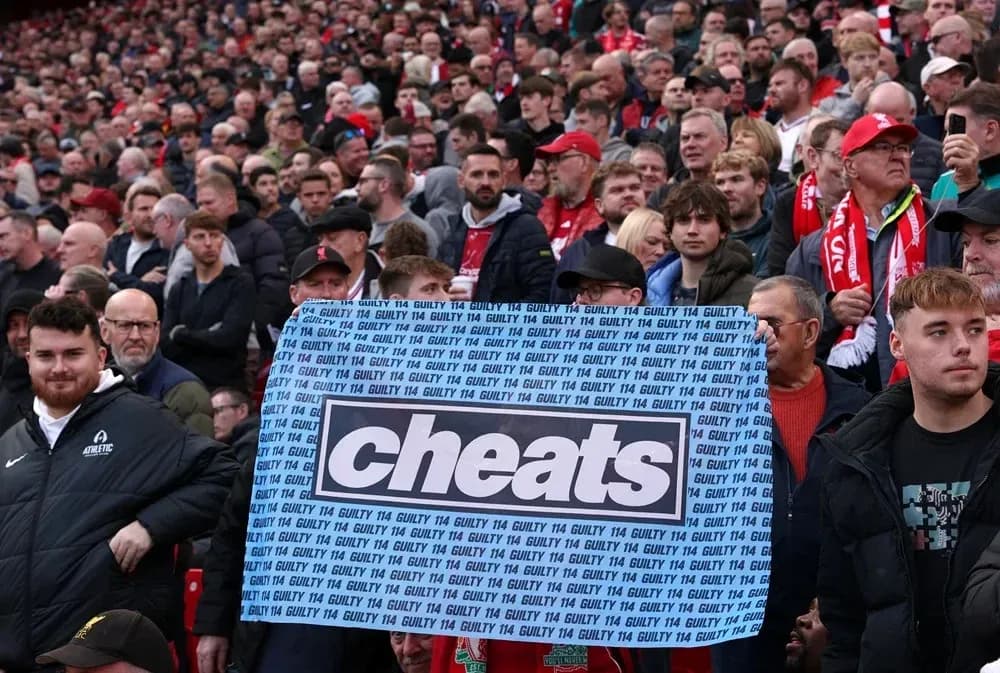 Supporters holding a banner with the word 'cheats' Supporters holding a banner with the word 'cheats'