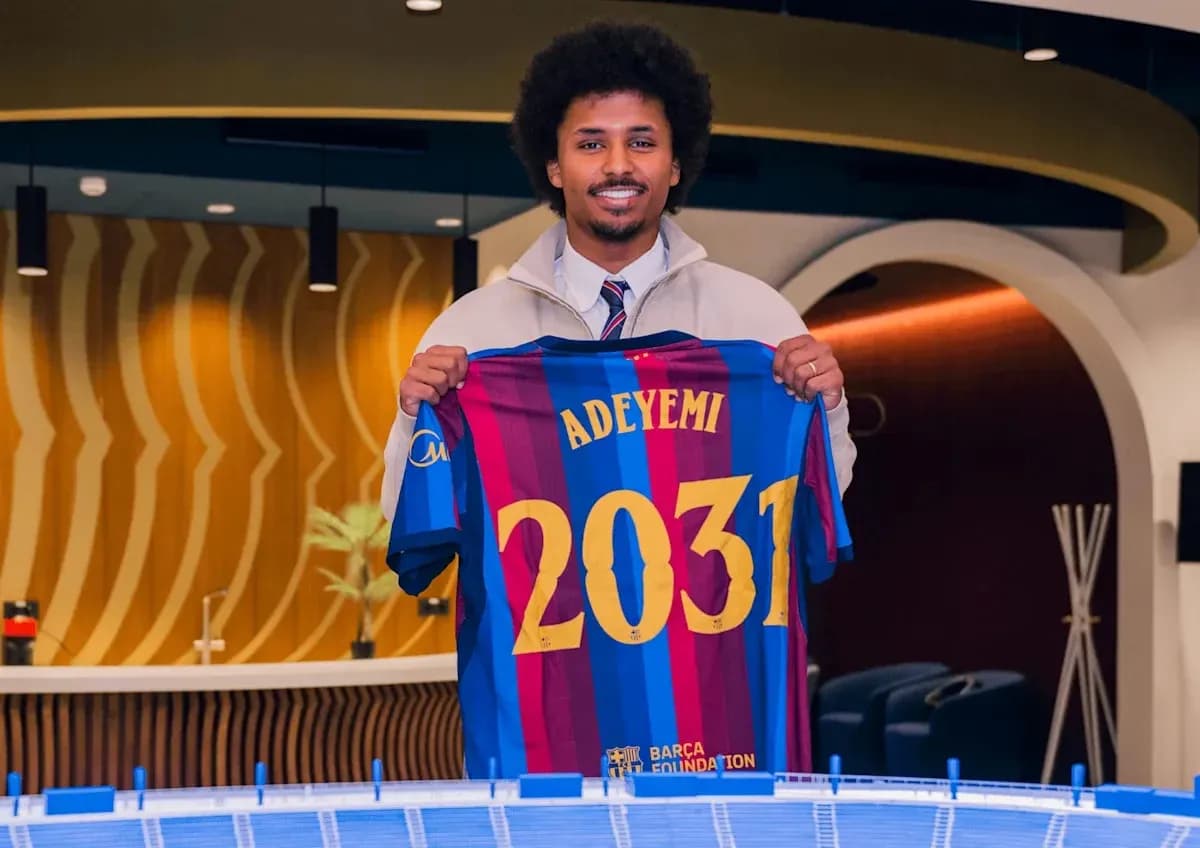 Joueur tenant un maillot du FC Barcelone avec 'ADEYEMI 2031' Joueur tenant un maillot du FC Barcelone avec 'ADEYEMI 2031'