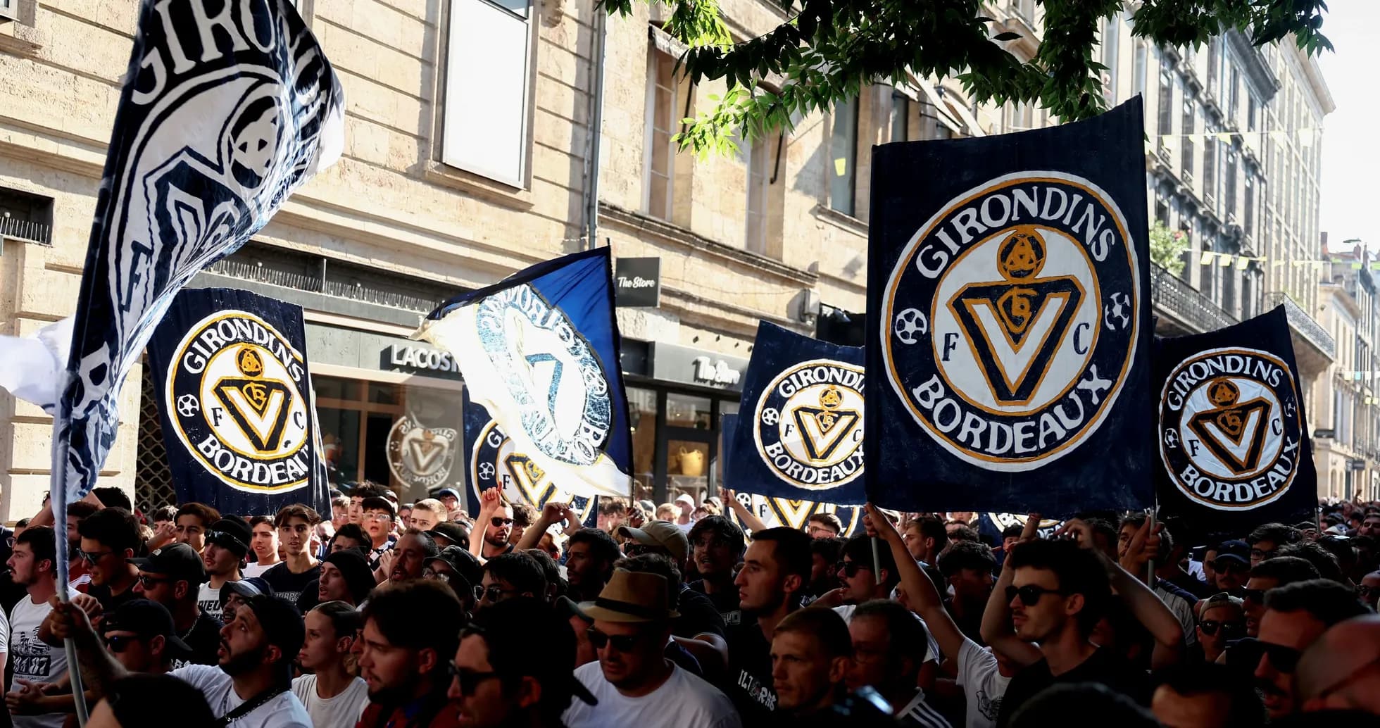 Supporters brandishing flags during Girondins de Bordeaux rally Supporters brandishing flags during Girondins de Bordeaux rally