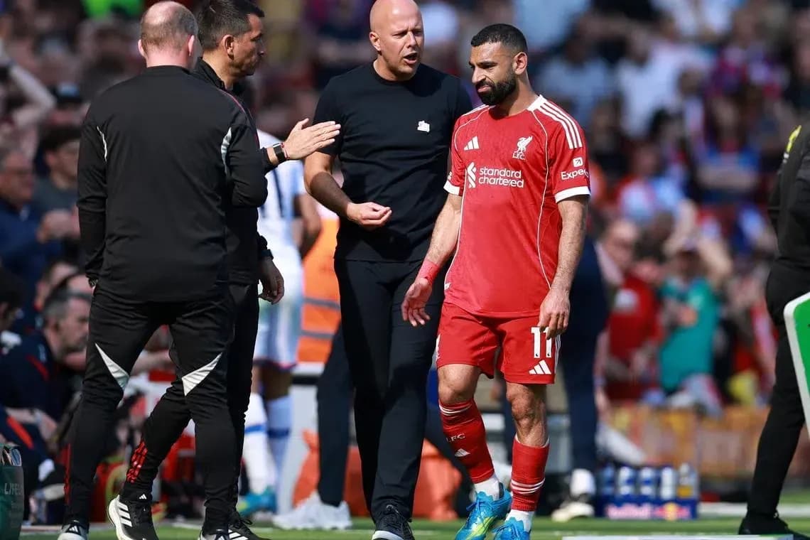 Mohamed Salah leaving the pitch with staff Mohamed Salah leaving the pitch with staff