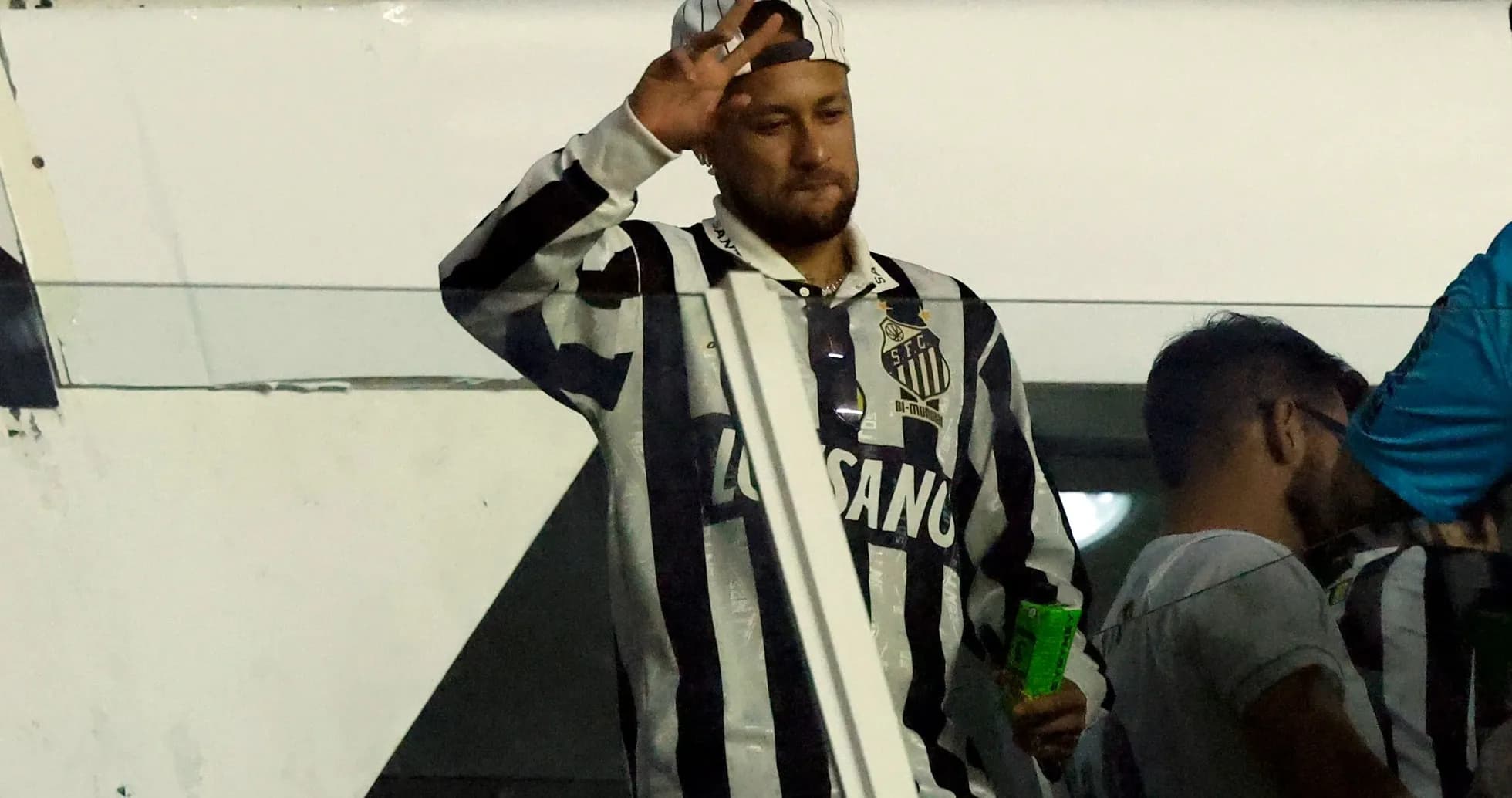 Supporter waving in Santos FC jersey at stadium Supporter waving in Santos FC jersey at stadium