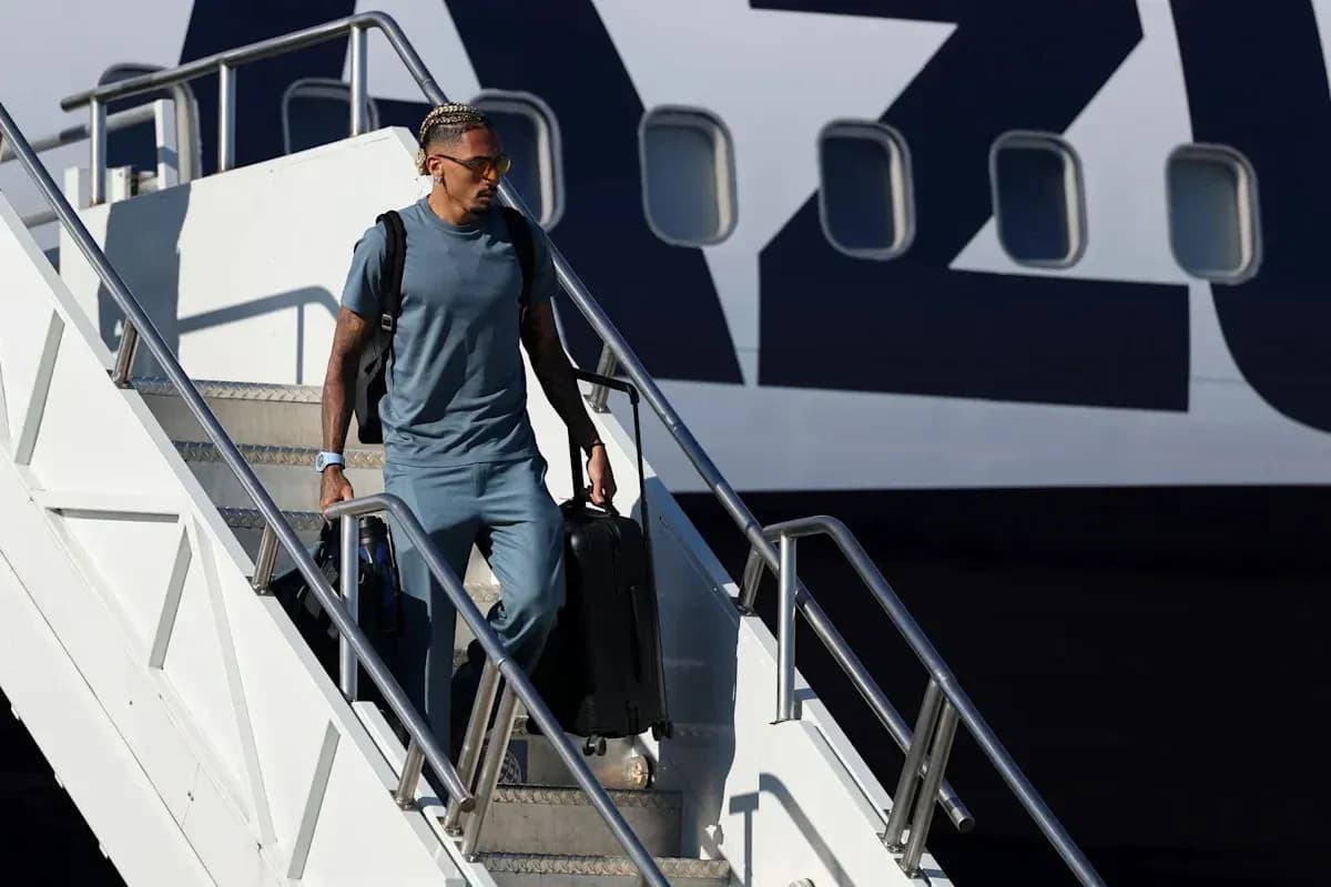 Joueur descendant de l'avion avec une valise Joueur descendant de l'avion avec une valise