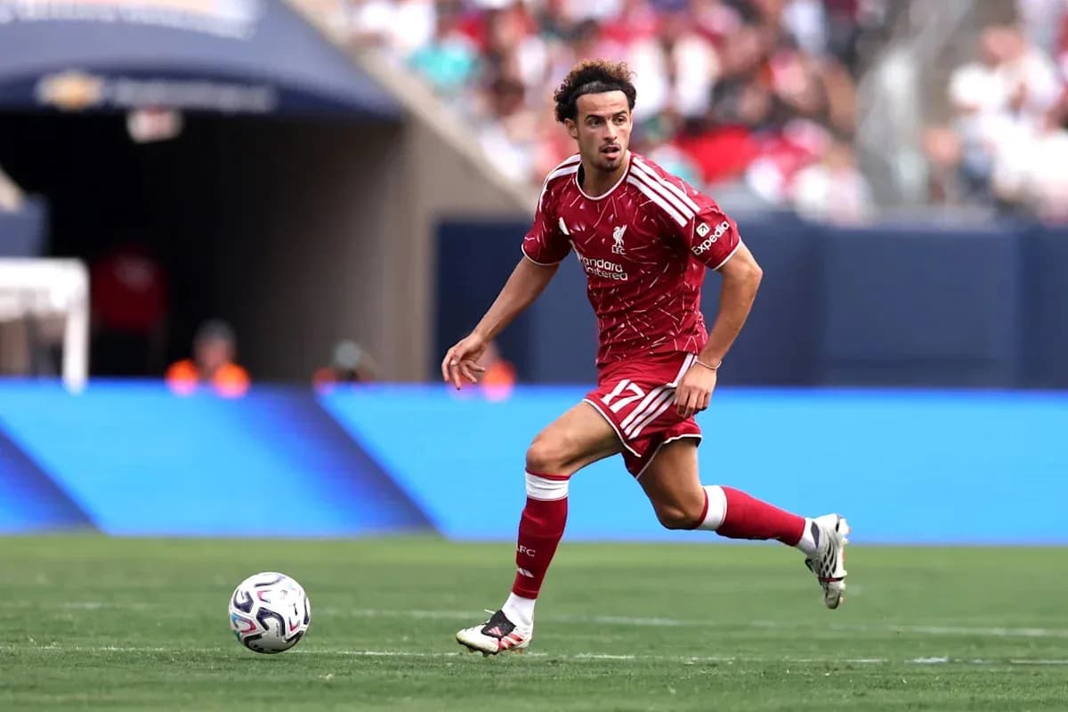 Joueur de Liverpool courant avec le ballon sur le terrain Joueur de Liverpool courant avec le ballon sur le terrain