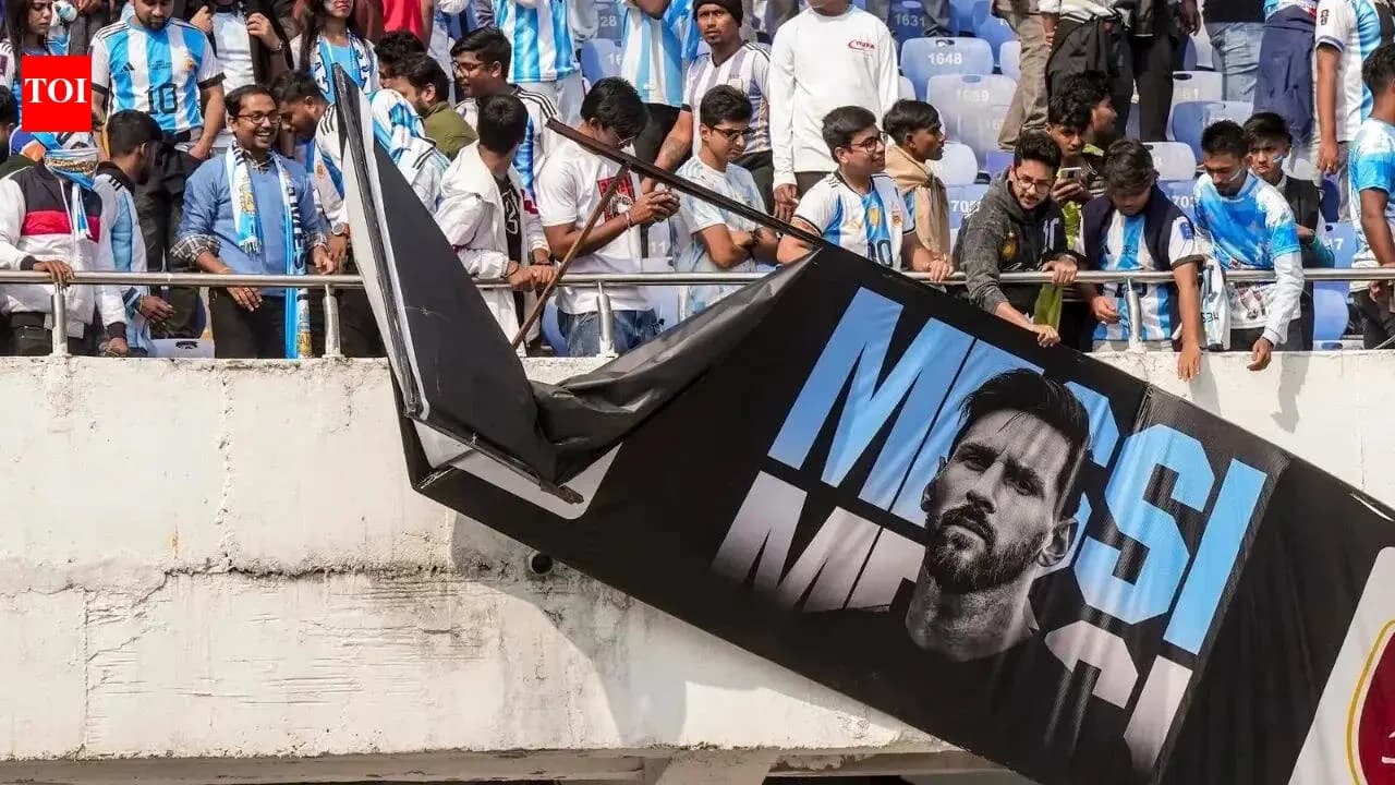 Supporters with Argentina jerseys near Messi banner Supporters with Argentina jerseys near Messi banner