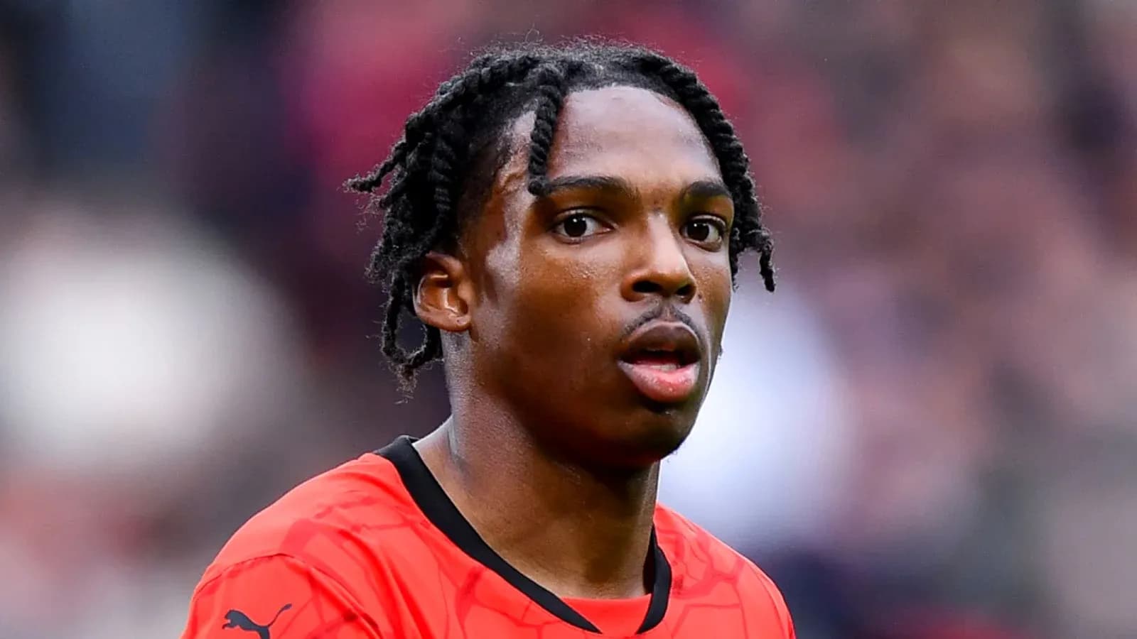 Joueur en maillot rouge sur le terrain Joueur en maillot rouge sur le terrain