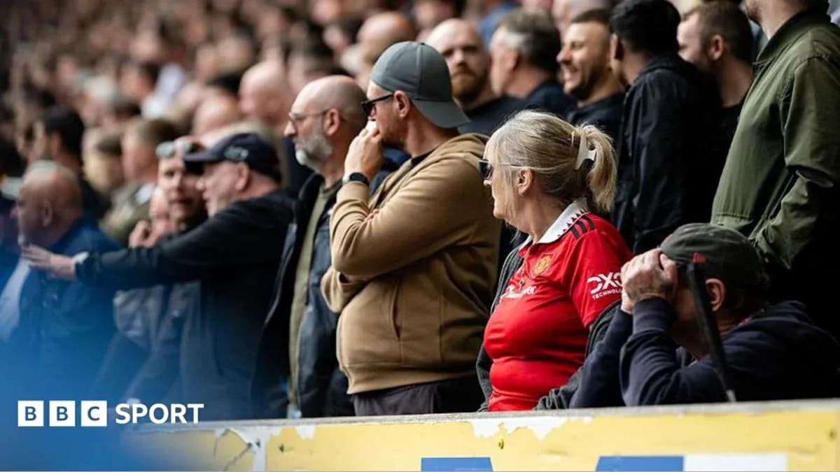 Supporters watching a match in the stands Supporters watching a match in the stands