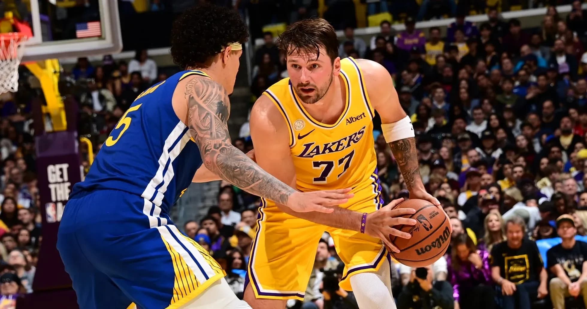 Joueur des Lakers dribblant face à un adversaire Joueur des Lakers dribblant face à un adversaire