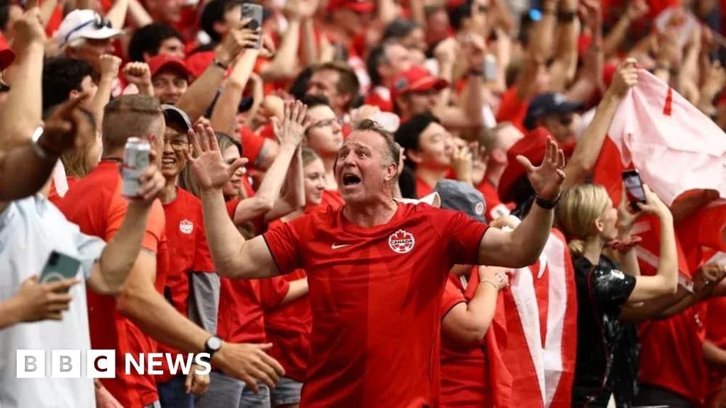Supporters in red celebrating during a match Supporters in red celebrating during a match