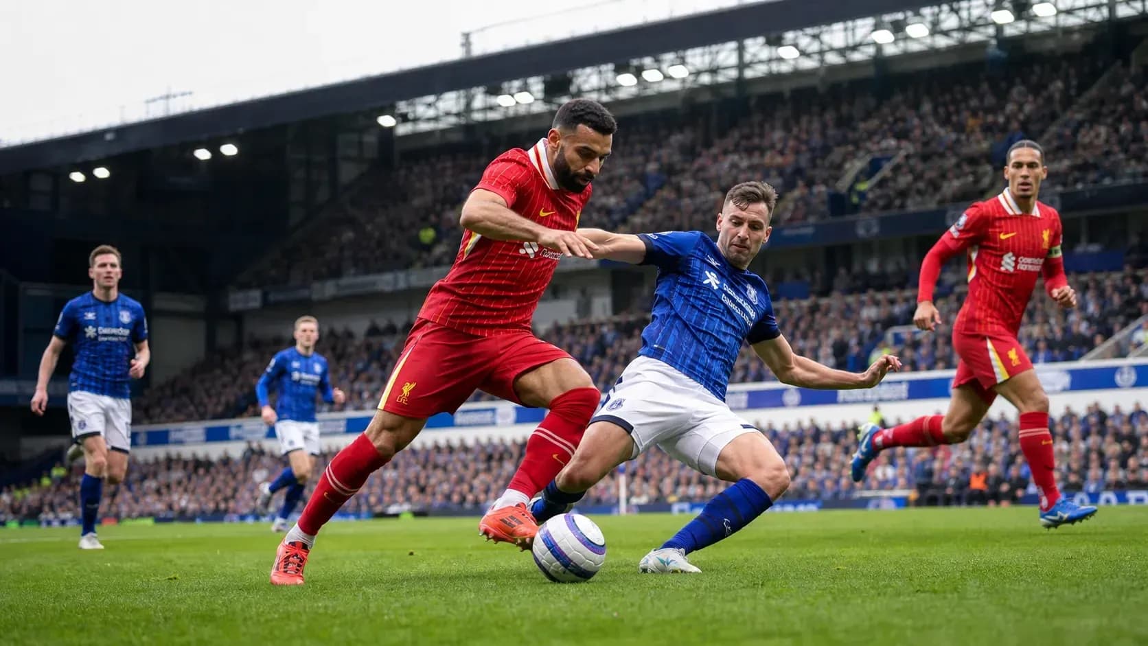 Joueurs de Liverpool et Everton en compétition pour le ballon Joueurs de Liverpool et Everton en compétition pour le ballon