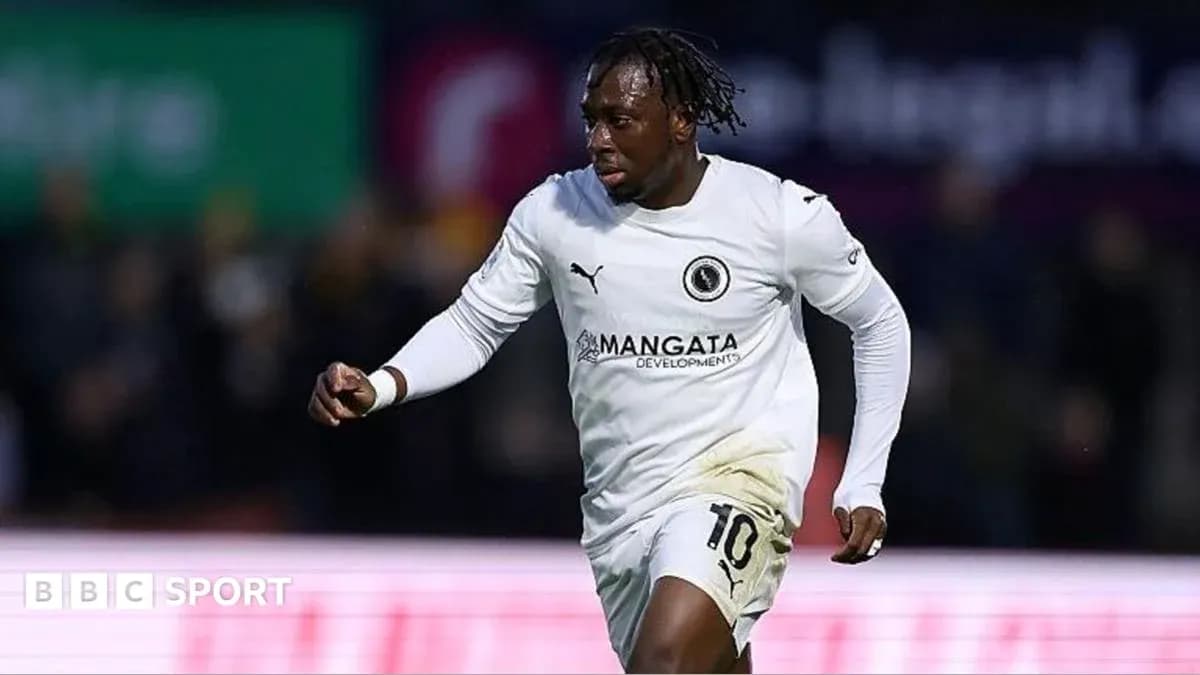 Joueur en maillot blanc célébrant un but sur le terrain Joueur en maillot blanc célébrant un but sur le terrain