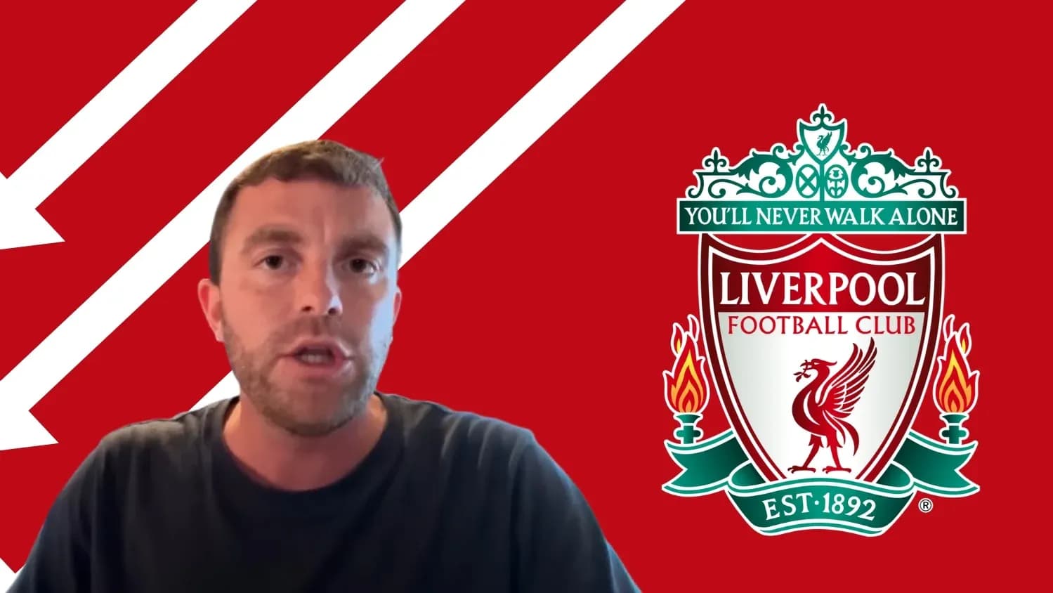Person speaking in front of Liverpool FC logo Person speaking in front of Liverpool FC logo