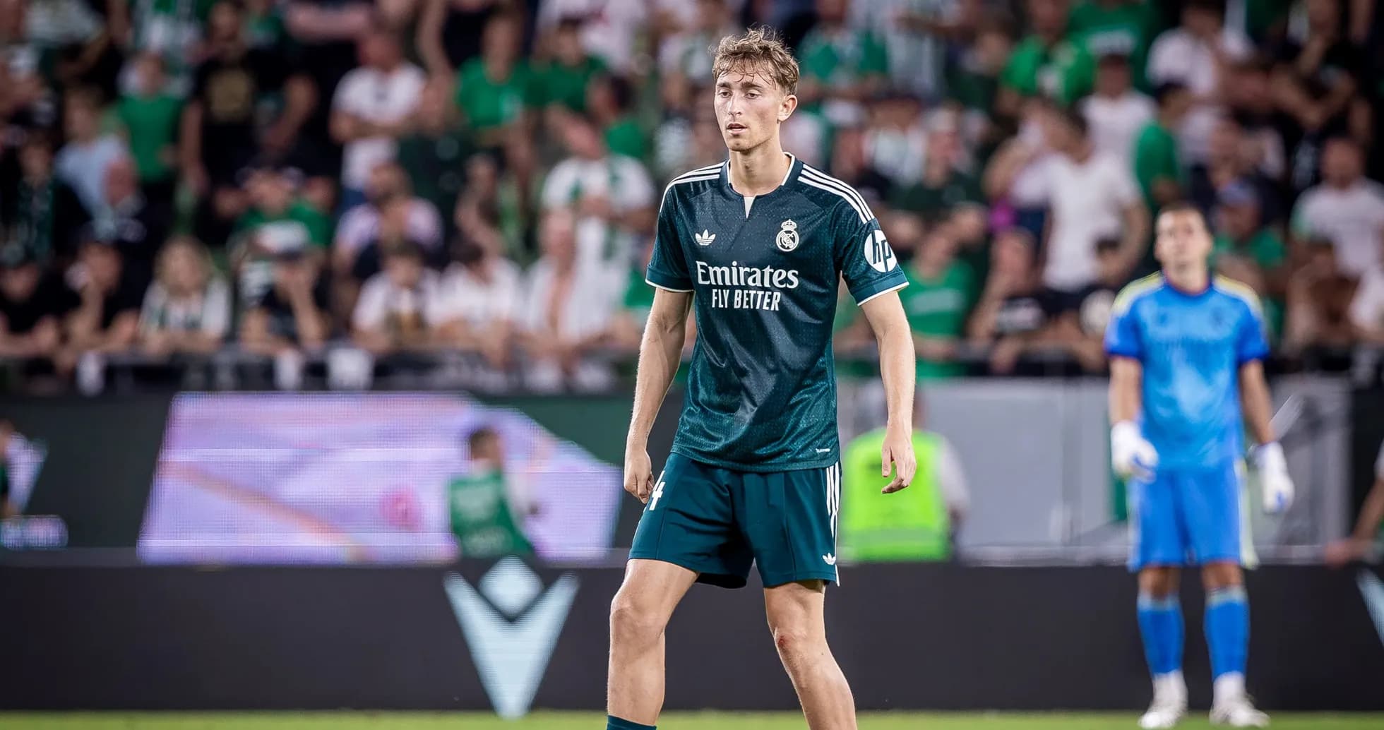 Joueur de Real Madrid sur le terrain avec supporters en arrière-plan Joueur de Real Madrid sur le terrain avec supporters en arrière-plan