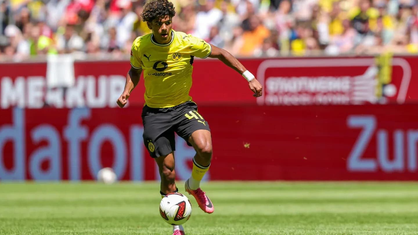 Joueur de Borussia Dortmund dribblant sur le terrain Joueur de Borussia Dortmund dribblant sur le terrain