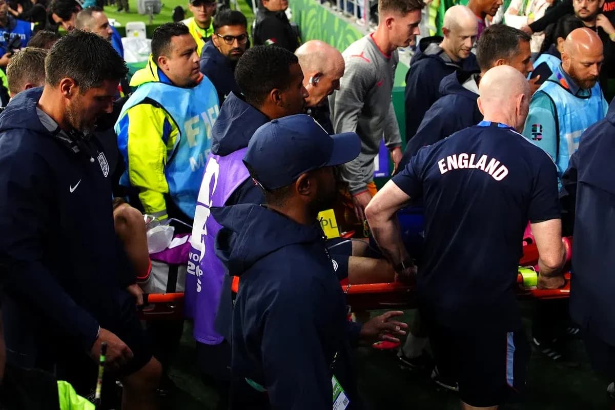 Staff assisting injured player off the field Staff assisting injured player off the field