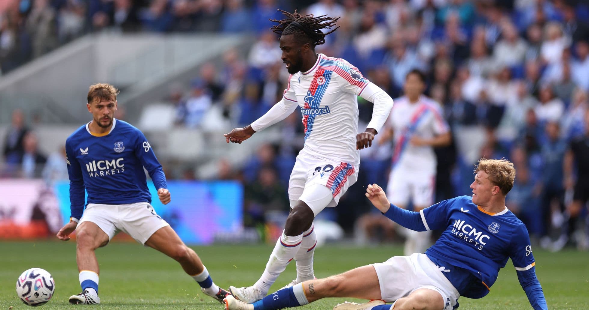 Joueur dribblant entre deux adversaires sur le terrain Joueur dribblant entre deux adversaires sur le terrain